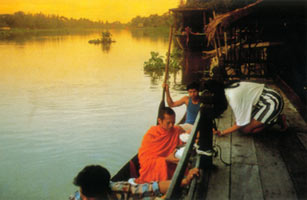 Offering alm to monks on Ta Chin river