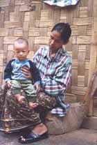 A Myanmar student taking care of a sick Lisu child