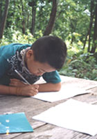 A Lisu child studying writing