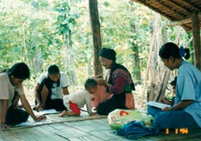 A Thai volunteering teacher teaching Thai to Lisu villagers, Mae Hong Son
